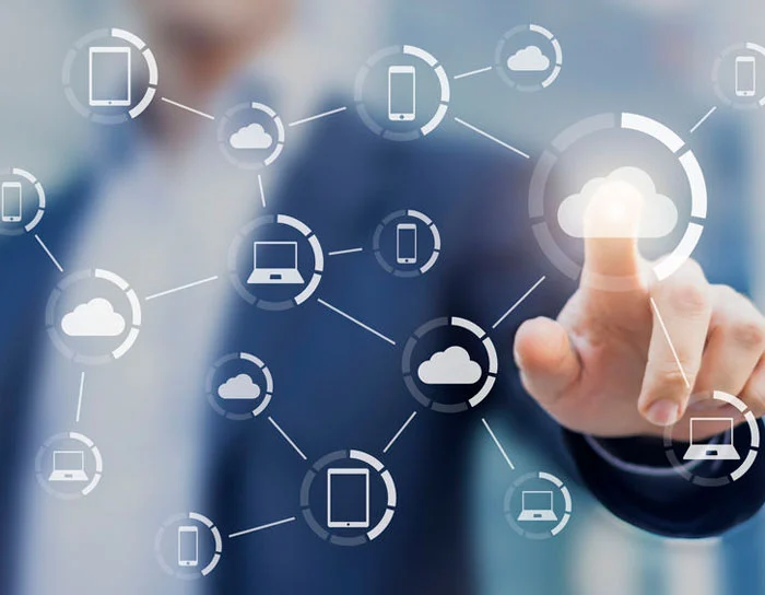 Cloud-Based HRMS A businessman interacting with a digital cloud network, symbolizing cloud computing and data connectivity.