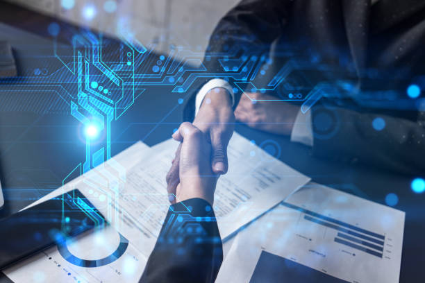 Business handshake over documents with digital tech overlay.