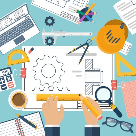 wa4 Top view of a workspace with engineering tools, blueprints, laptop, coffee, and stationery.