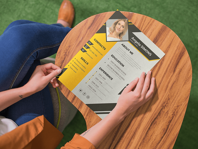 1608881068-15677347135fe593ac636a47-88970044 Woman reviewing a printed resume with modern design and layout
