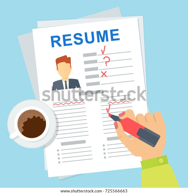 Hand reviewing a resume with corrections and coffee beside